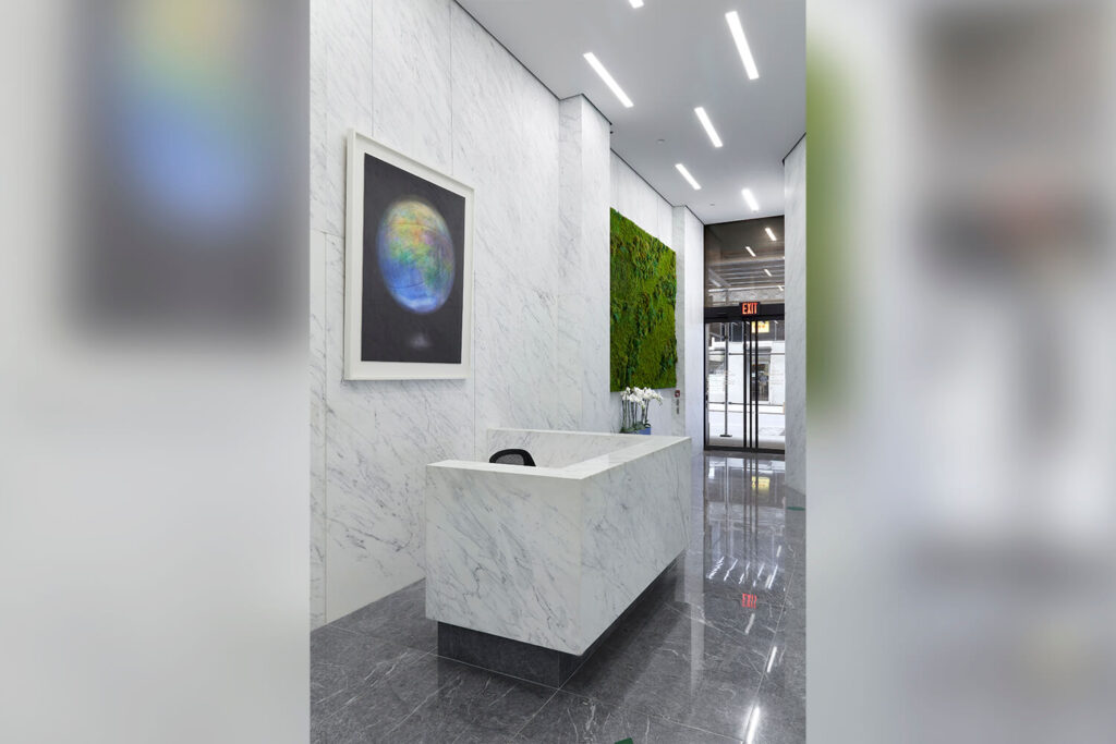 Lobby with white marble desk & walls
